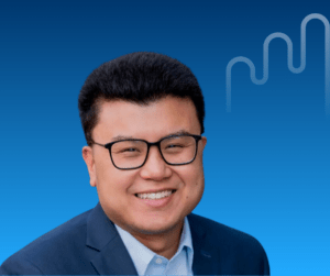 Smiling man (Ching) with glasses in a suit against a blue gradient background, featuring a minimalist line design. Professional and friendly tone.