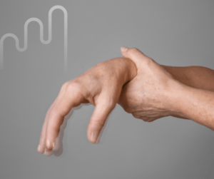 A hand with fingers curling downward, held by the opposite hand, against a gray background with a faint curved line pattern. Tone suggests tension.