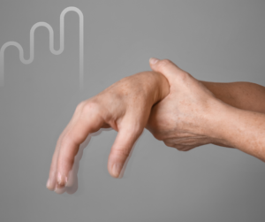 A hand with fingers curling downward, held by the opposite hand, against a gray background with a faint curved line pattern. Tone suggests tension.